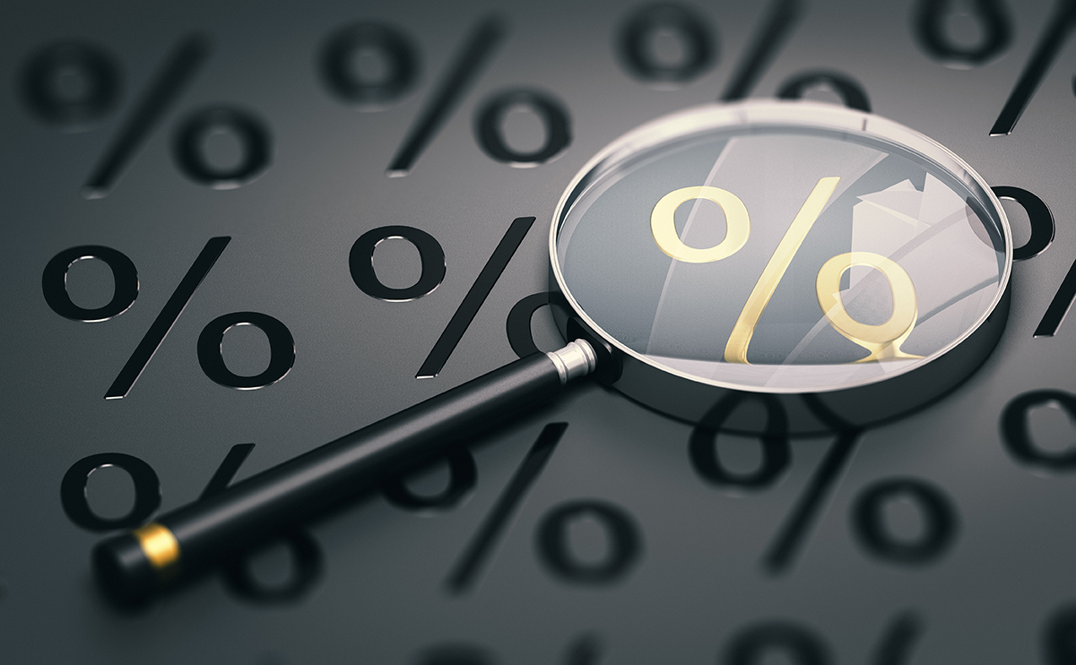 magnifying glass looking at a percentage symbol