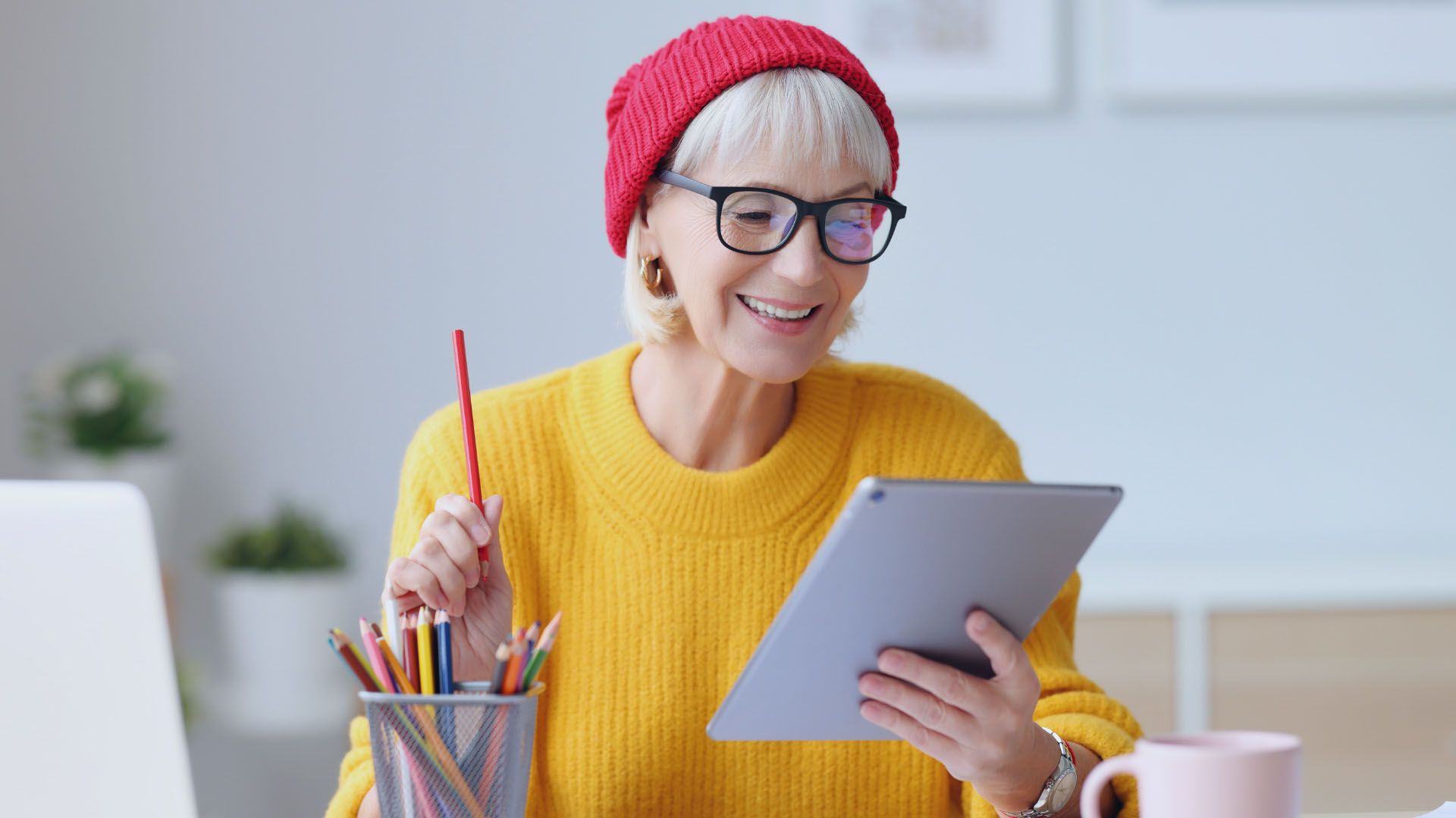 Woman in yellow top reading on her ipad