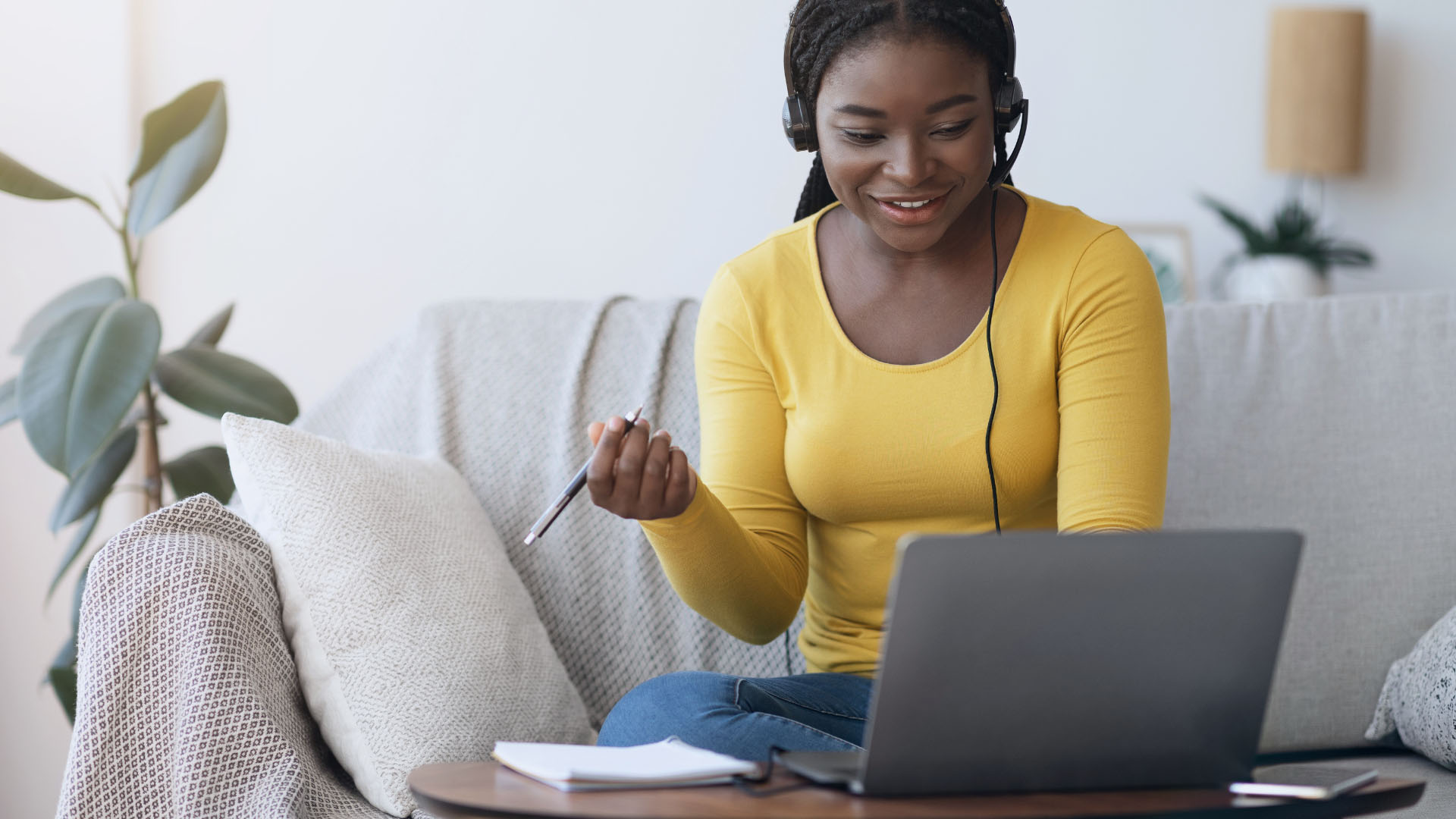 Woman on laptop watching something on her computer