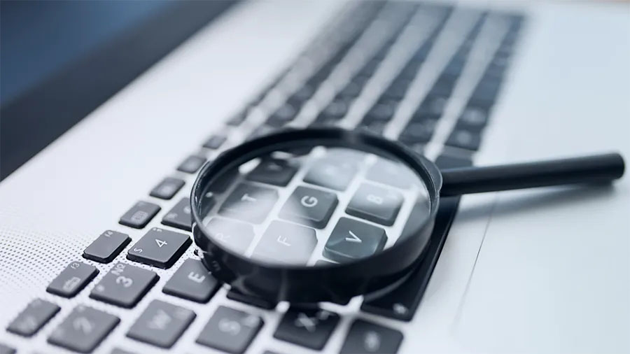 keyboard with a magnifying glass on the letter g