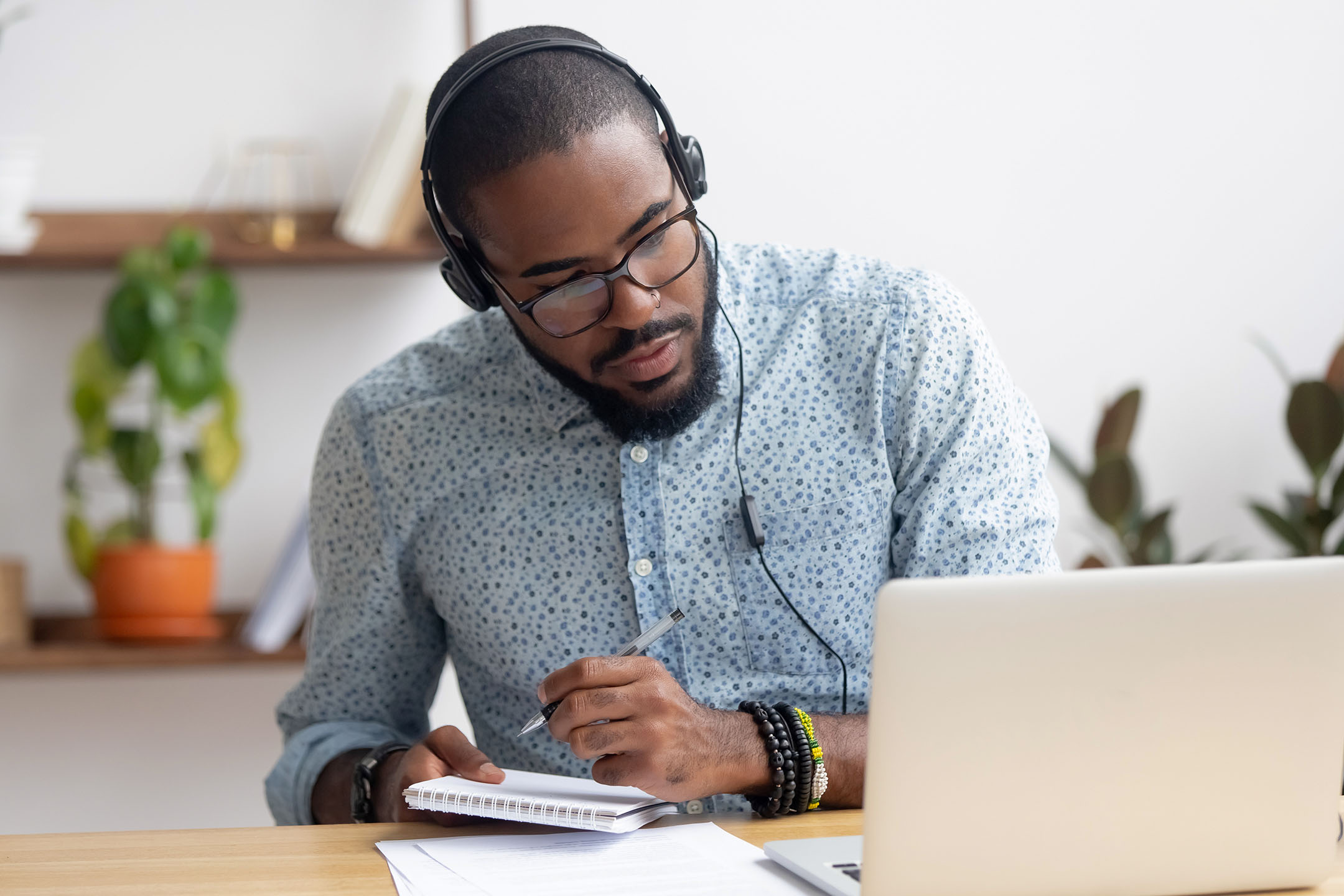 Man with headphones on laptop studying